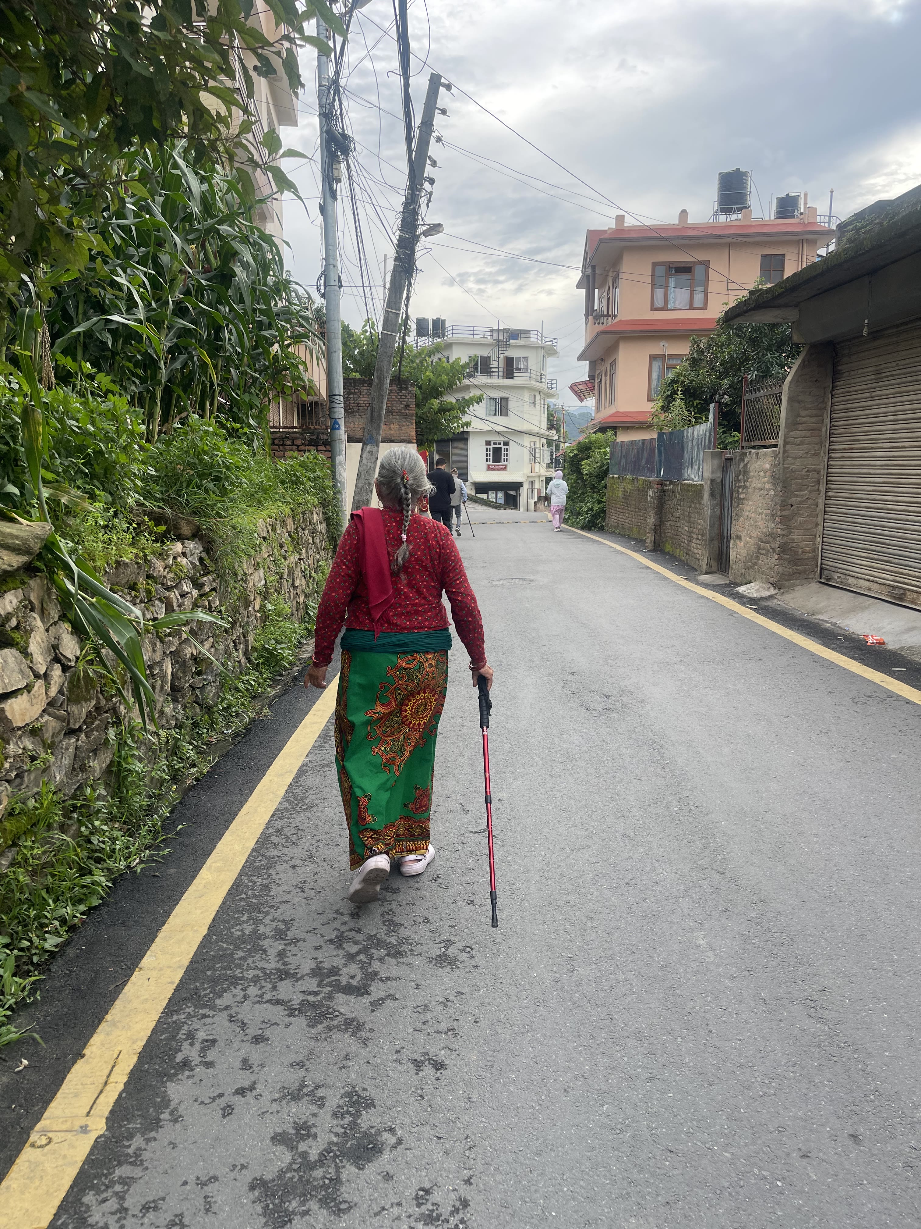 An elder walking on a road in Kathmandu